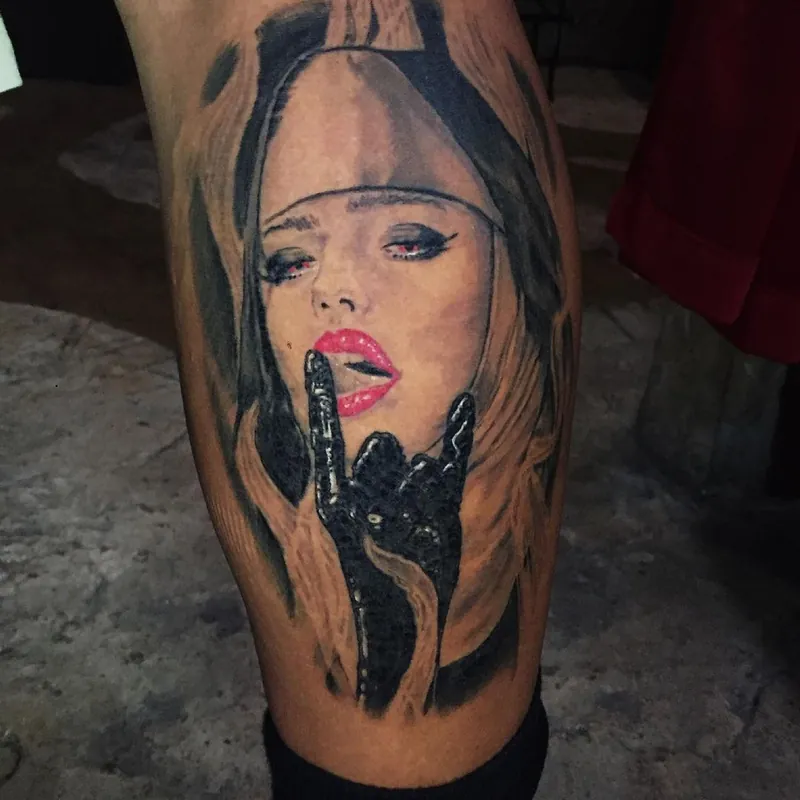 Black and grey realism tattoo on the calf of a woman in a nun's habit with red eyes and lips, a shadowed hand near her mouth.