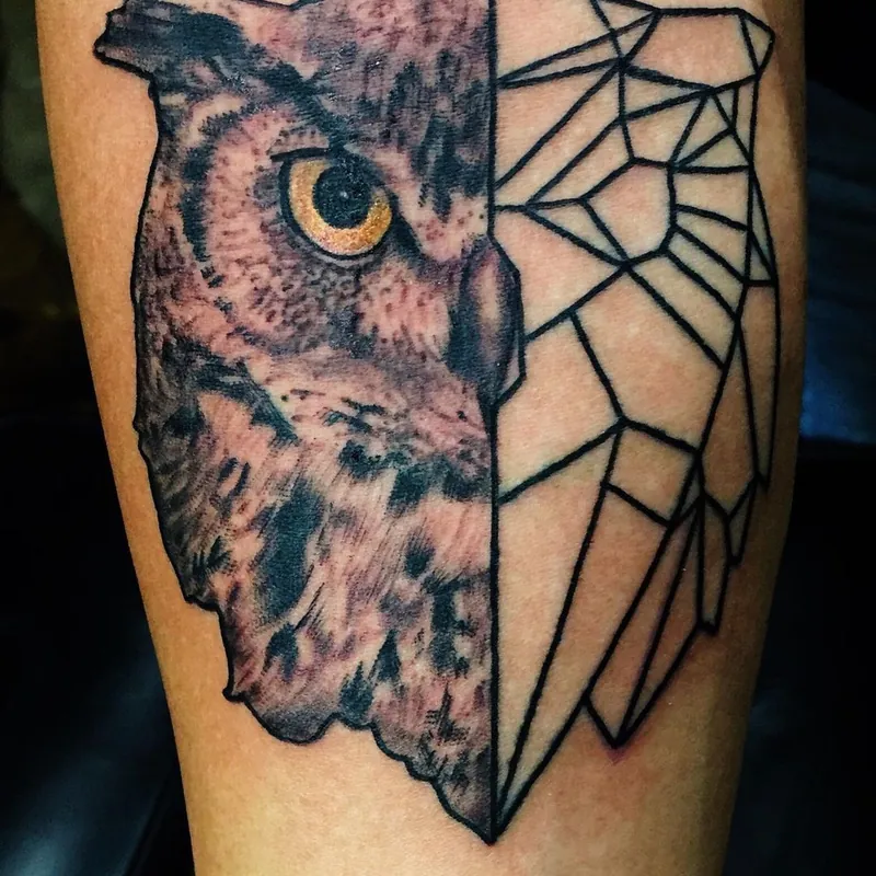 Tattoo on a forearm of an owl's head split between black and grey realism on one half and geometric linework on the other.