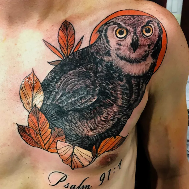 Color tattoo of an owl with wide yellow eyes perched among autumn leaves before an orange moon, with 'Psalm 91:1' lettering below on the chest.