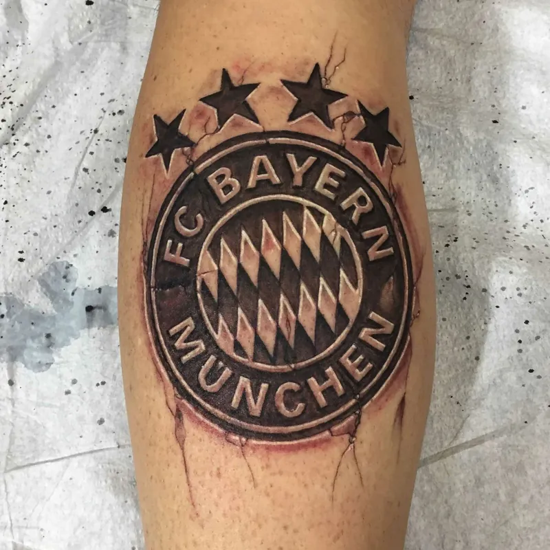 Black and grey tattoo of the FC Bayern Munchen crest with five stars above it, styled to look like a branded stamp on the calf.