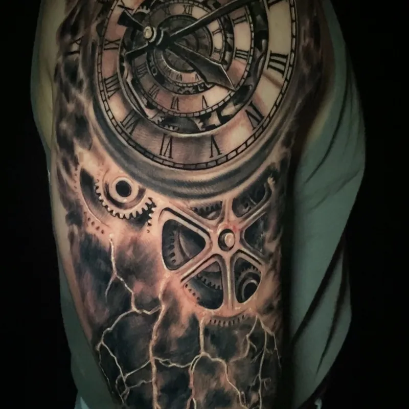Black and grey realism tattoo of an ornate pocket watch face with exposed clockwork gears cracking apart under jagged lightning, on the upper arm.