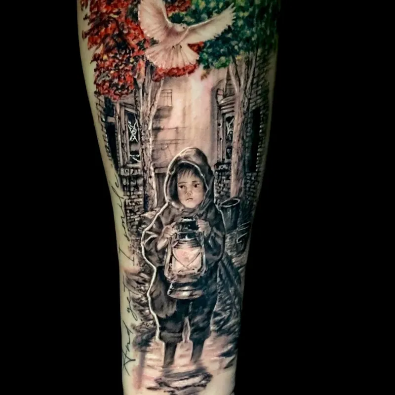 Color tattoo on the forearm of a hooded child holding a lit lantern in a war-torn city street, with a dove flying above red and green treetops.