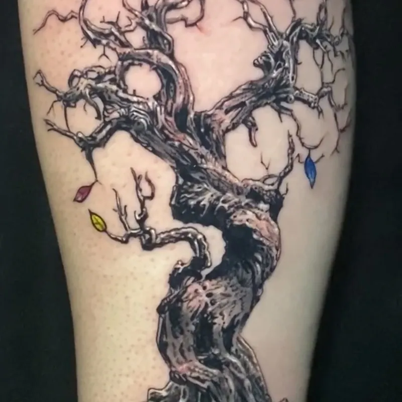 Black and grey tattoo of a gnarled leafless tree with twisting branches and exposed roots, with a few red, blue, purple, and yellow leaves left on the limbs.
